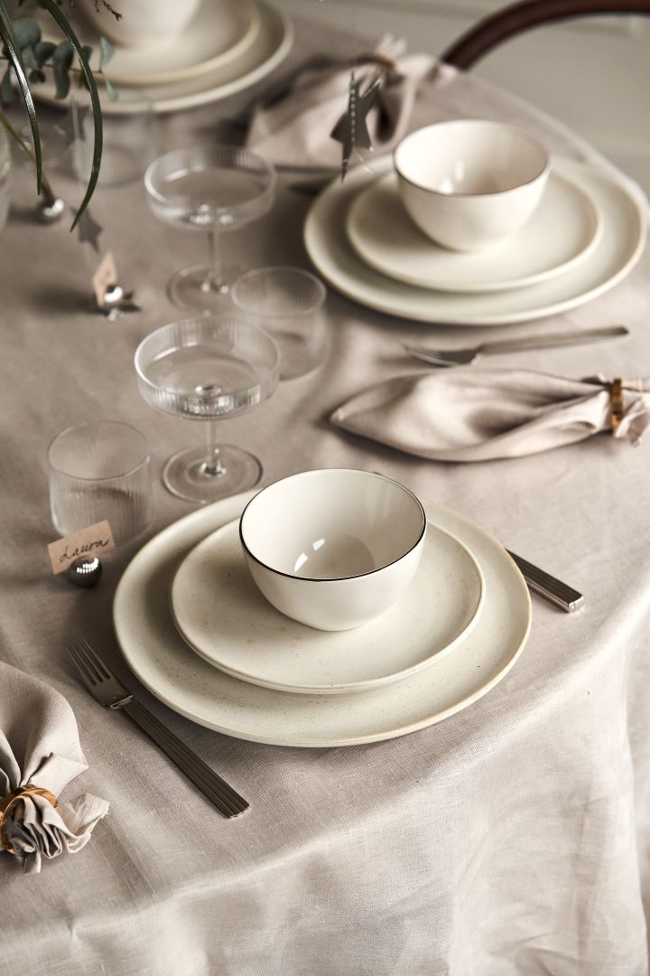 New year party ideas - an elegant white table setting with plates from Ernst and the famous Ripple glasses from ferm LIVING.