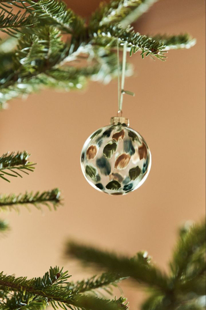 Explore nature-themed Christmas tree decoration ideas like the Overcast bauble in greens and browns from Scandi Living. 