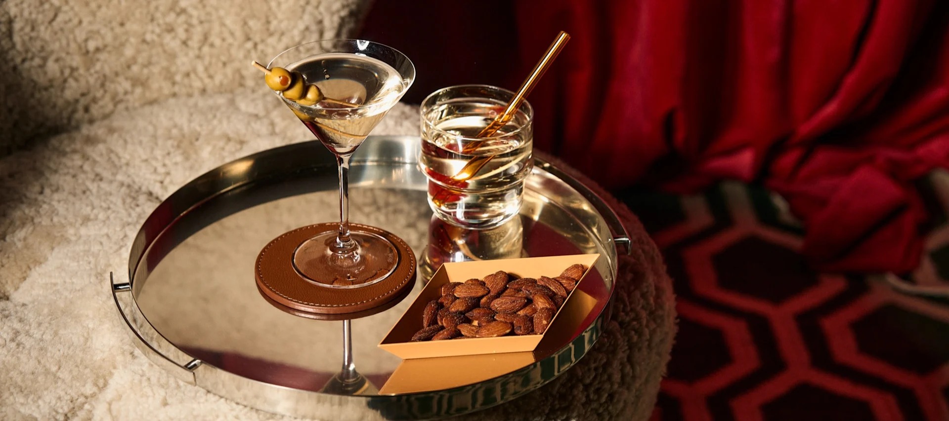 There are many types of cocktail glasses like the martini glass and the tumbler you see here on a mirrored tray from Spiegelau.