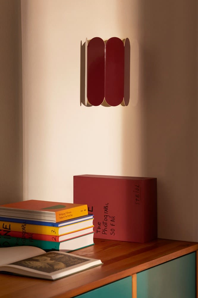 The Arc wall lamp in this season's favourite shade of red. The scalloped edges are the perfect update to any home with these modern lighting ideas. 