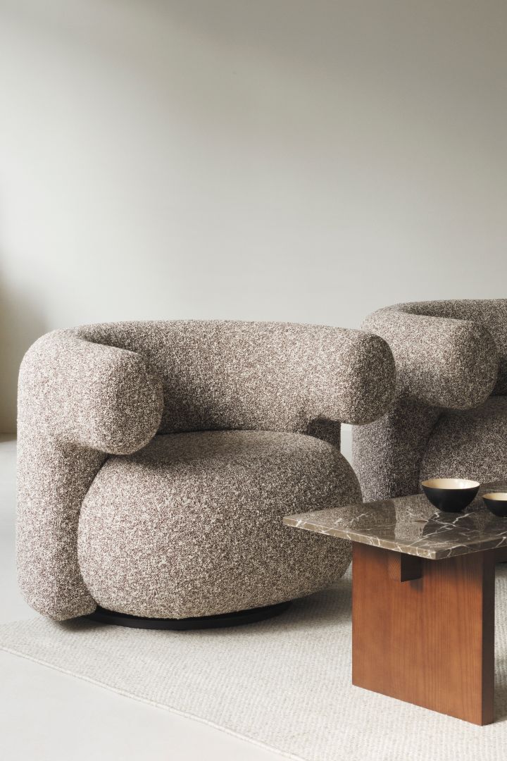 The chunky Burra arm chair from Normann Copenhagen seen here with a wooden and granite coffee table is right on trend this years autumn interior design trends. 