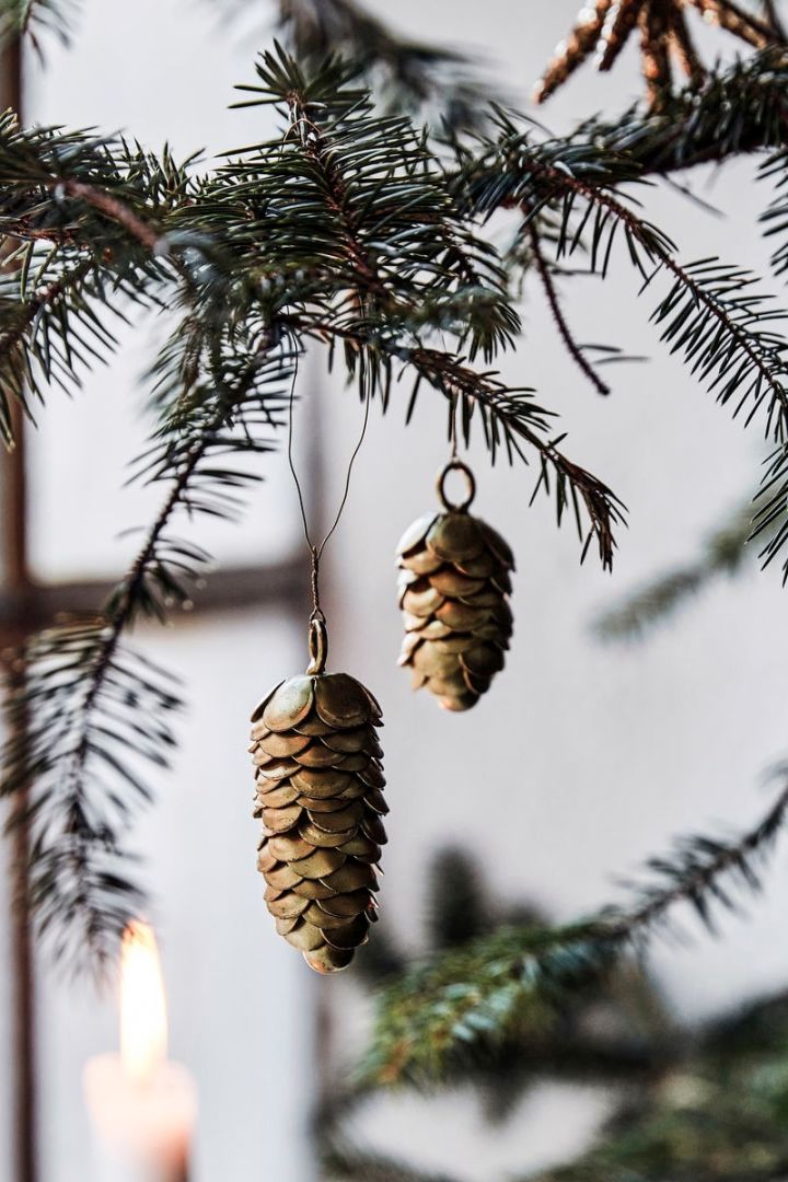 Use nature inspired Christmas tree decoration ideas like the brass pine cones from House Doctor. 