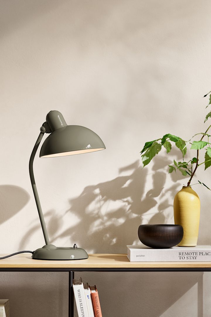 The interior colour trends for 2025 includes a natural shade of olive green, here you see the Kaiser Idell lamp from Fritz Hansen standing on a sideboard. 