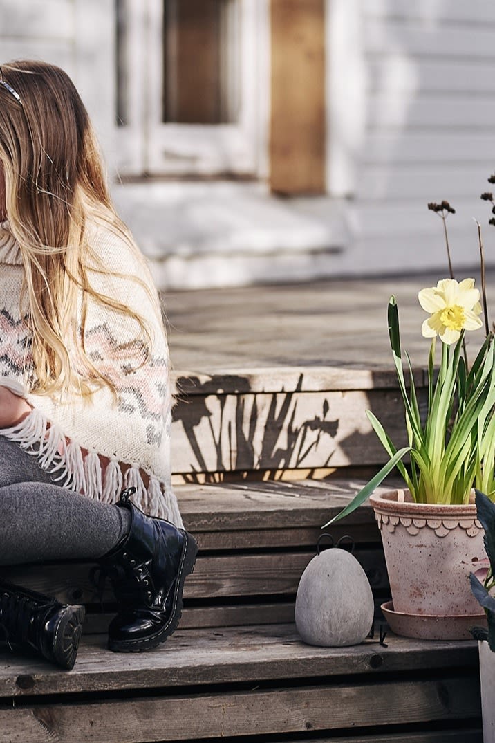 A little Easter bunny sits next to some quirky but stylish outdoor Easter decoration in the form of the Heavy Hen from DBKD. 