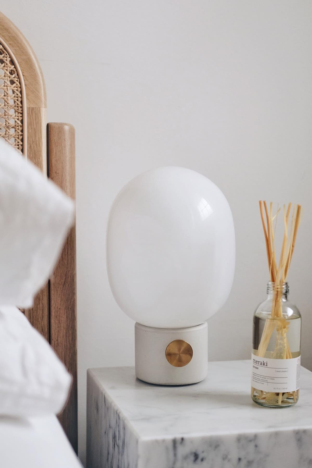 The JWDA table lamp from Audo Copenhagen stands on @tien.athome's bedside table, next to a diffuser from Meraki.