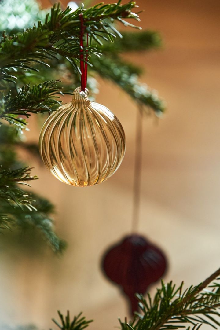 Glass baubles are perfect Christmas tree decoration ideas, here you see the gold glass bauble Holiday from Scandi Living.