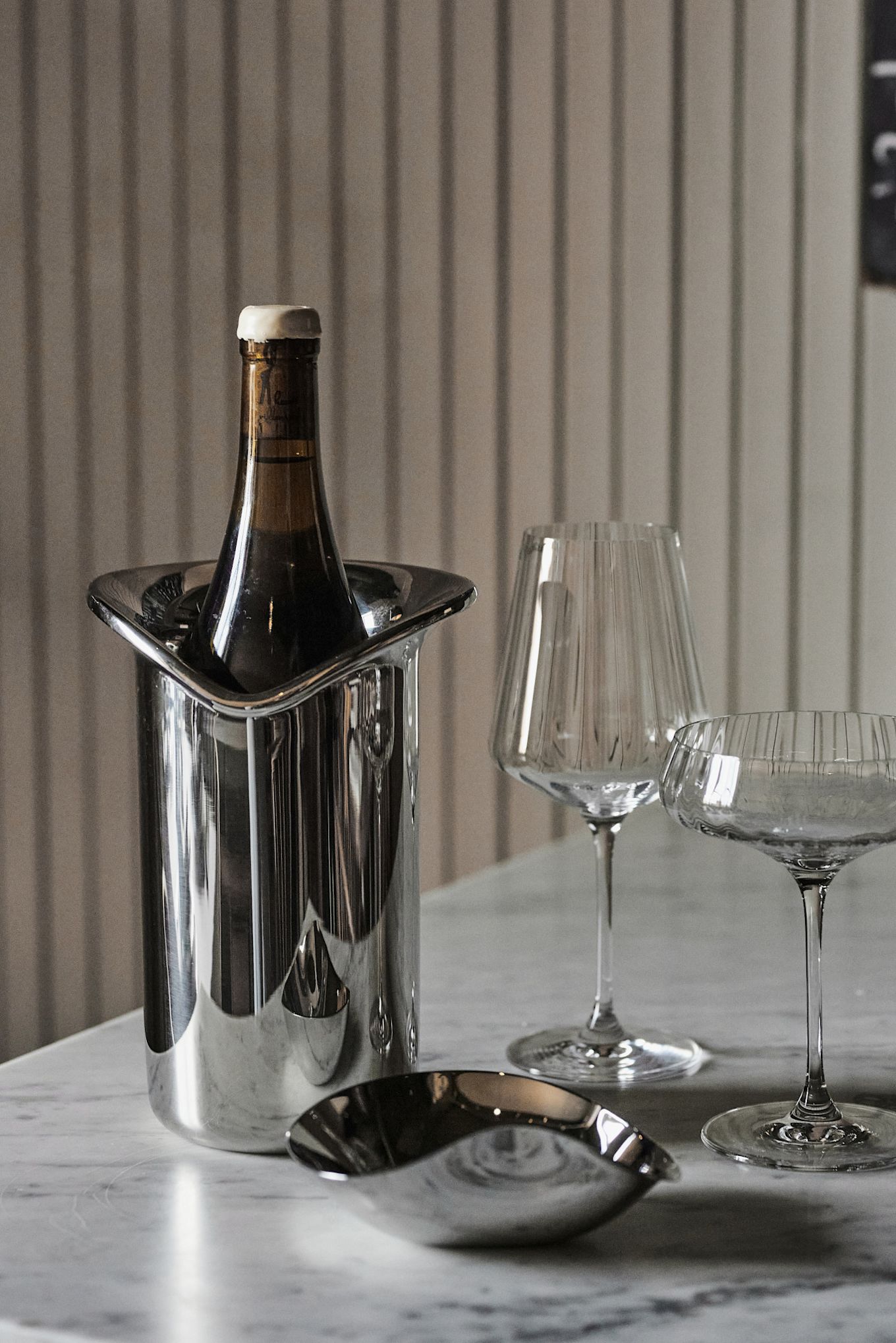 The Georg Jensen wine cooler in a white table setting idea seen here with the Bernadotte wine and champagne glasses.