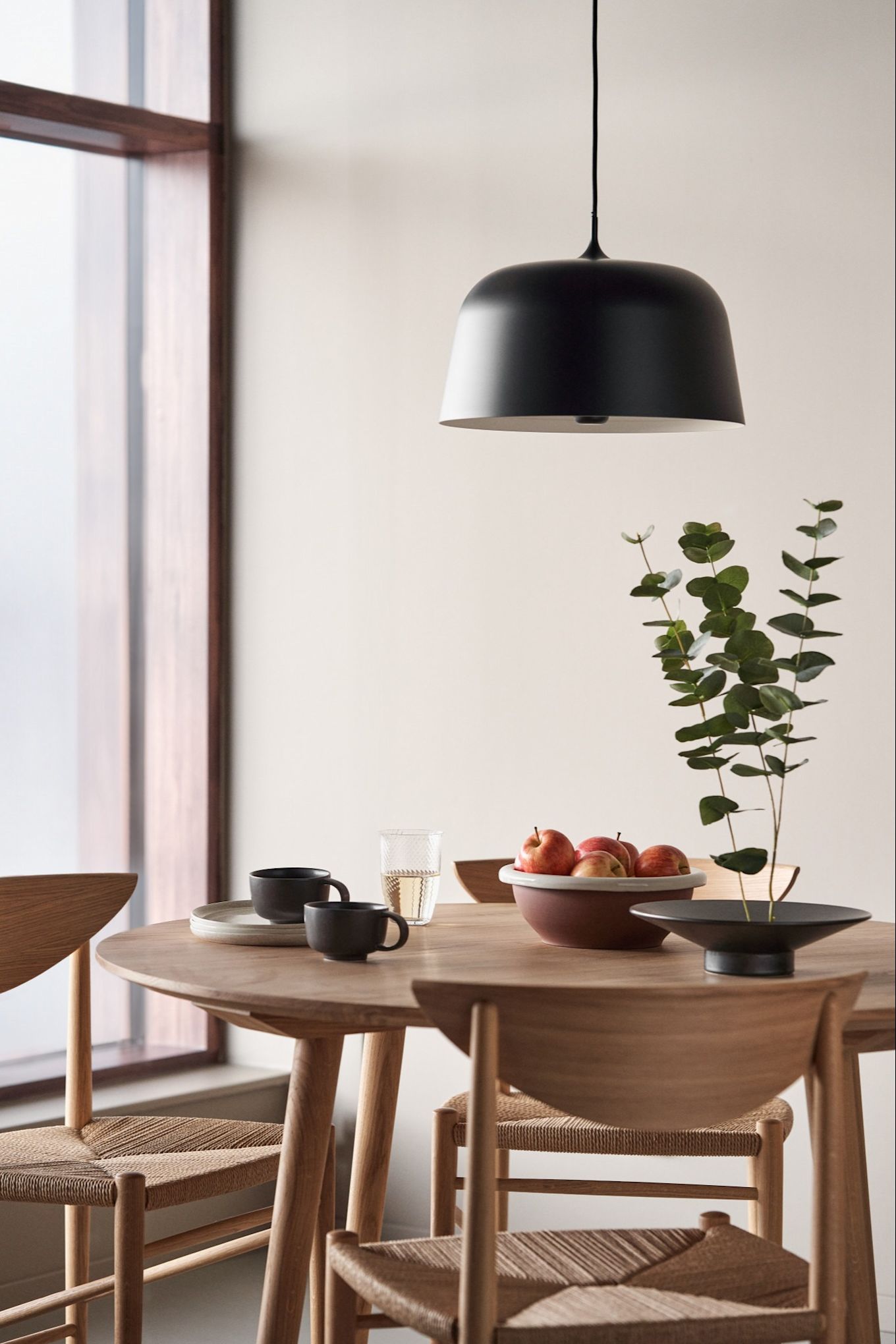 Refresh your home with modern ceiling lighting. Here you see the Halo ceiling light from Scandi Living in the colour black hanging over a round dining table.  