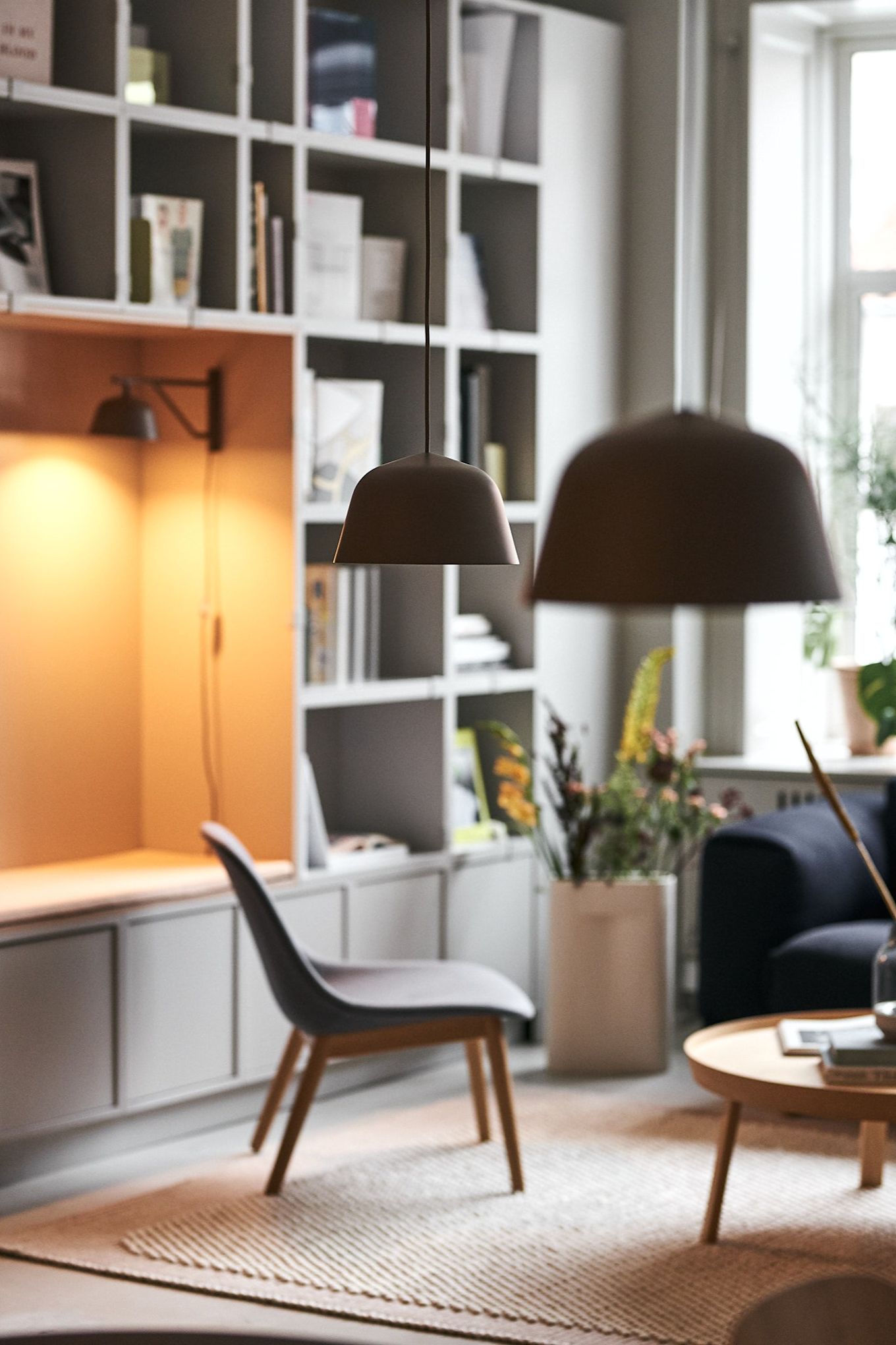 Ambit pendant and wall lamps from Muuto spread light and atmosphere in the lighting room. 