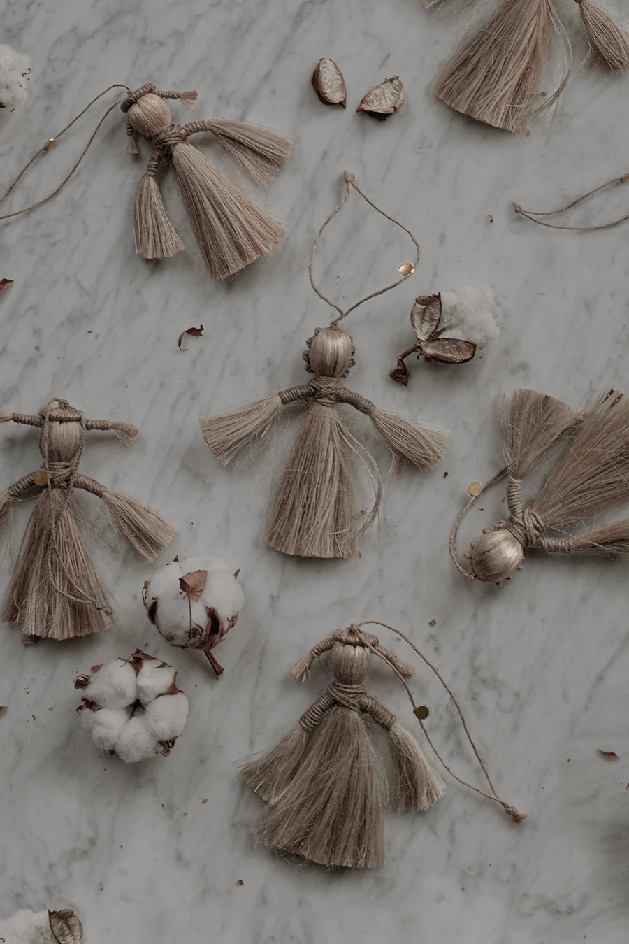 Here we see the wing angels from Ferm Living laying on a marble table top.