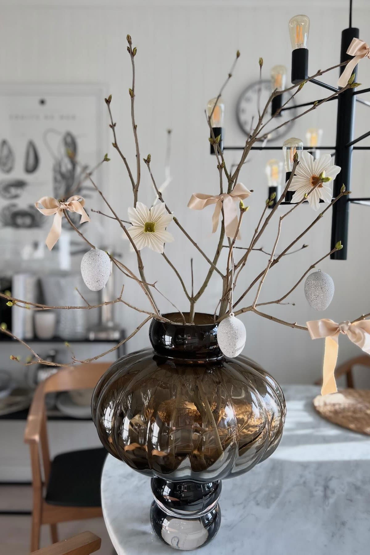 An Easter tree in the Balloon Vase by Louise Roe, decorated with eggs, flowers and bows in the home of @catarinaeldana.