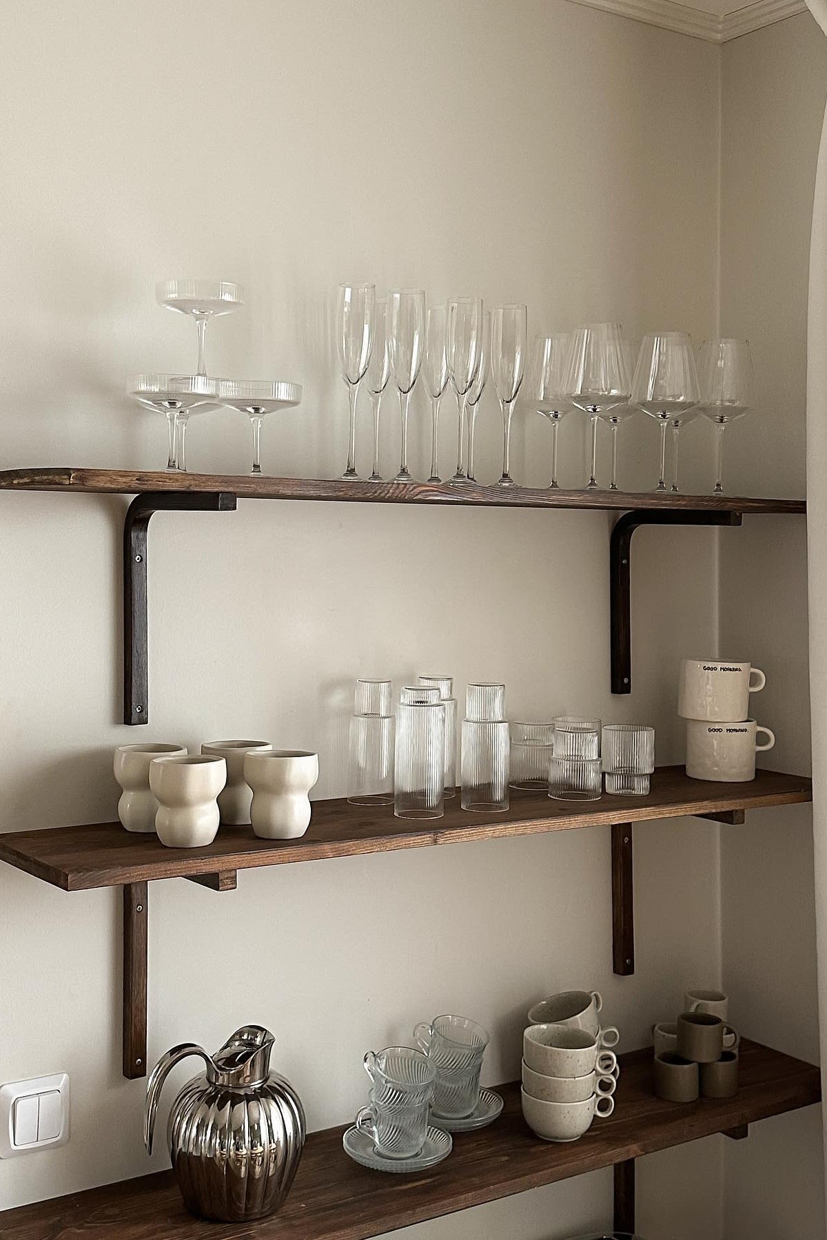 A shelf with glasses and cups near your coffee bar is also a good idea. Here you can see a three-level shelf with the Limfjord mugs from Broste Copenhagen, various Ripple glasses from ferm LIVING and the Freckle mugs from Scandi Living in the kitchen of Swedish influencer Joanna Avento.