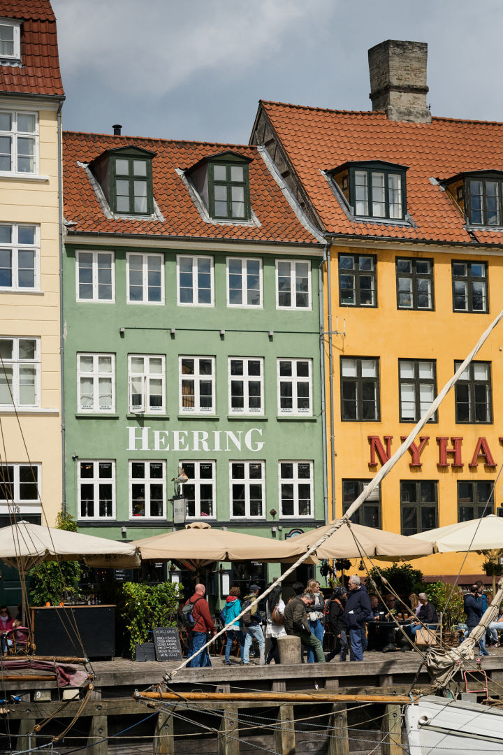 A stop at Nyhavn Harbour is a must on any tour of Copenhagen. Here you see the colourful houses on the harbour and some boats. 