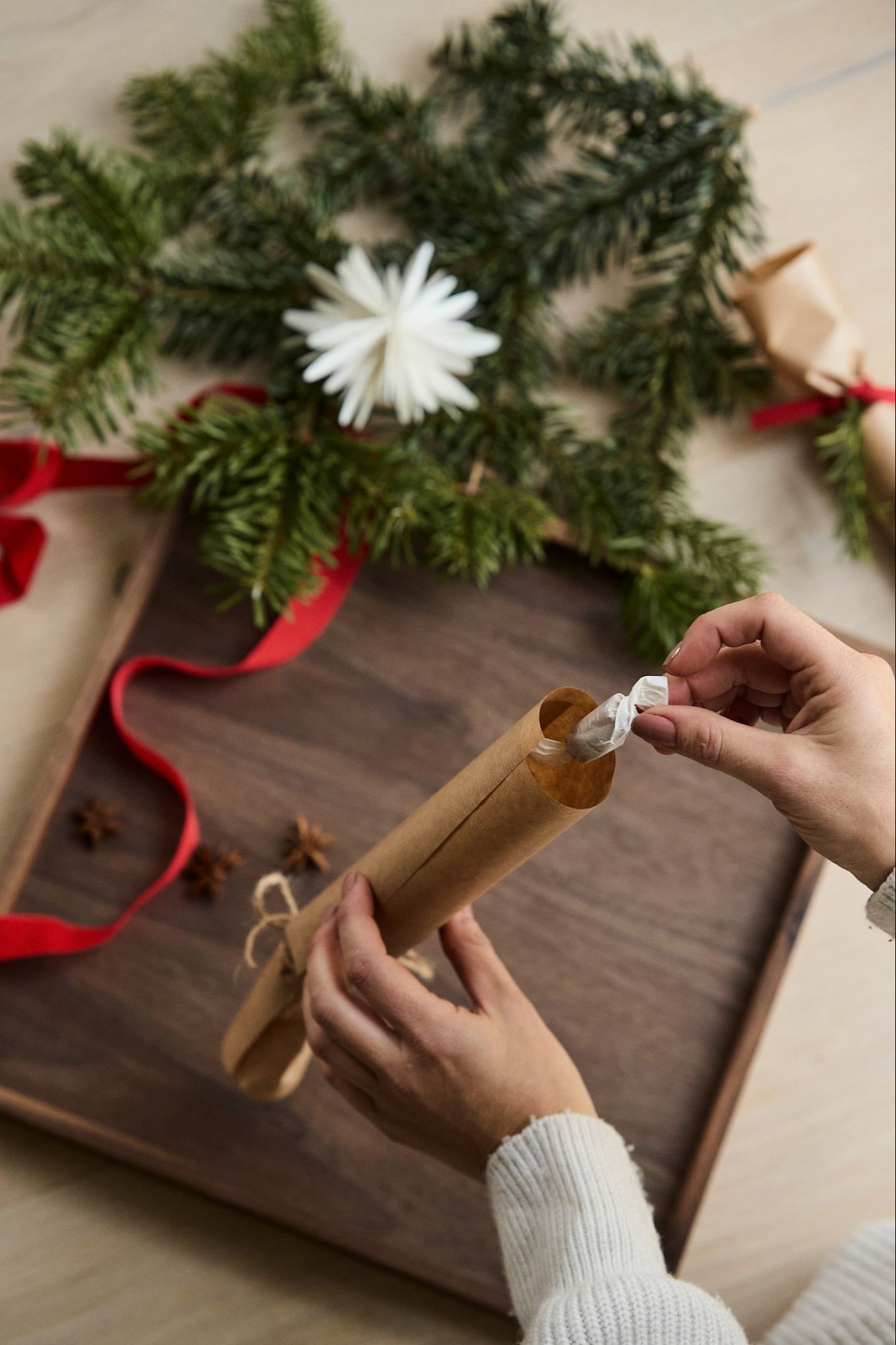 Step 4 in making your own Christmas cracker - add your candy and small gifts to the cracker. 