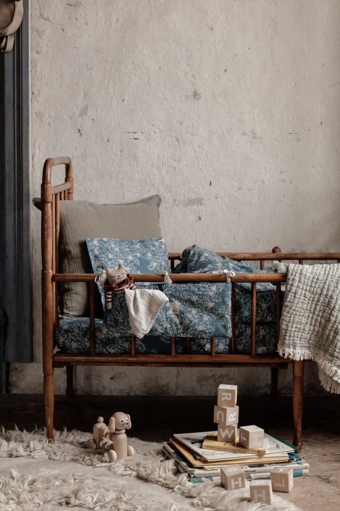 Here you see a rustic cot dressed in the Fauna Forest bed set from Garbo&Friends with a match crib pocket, the perfect baby shower gift ideas. 