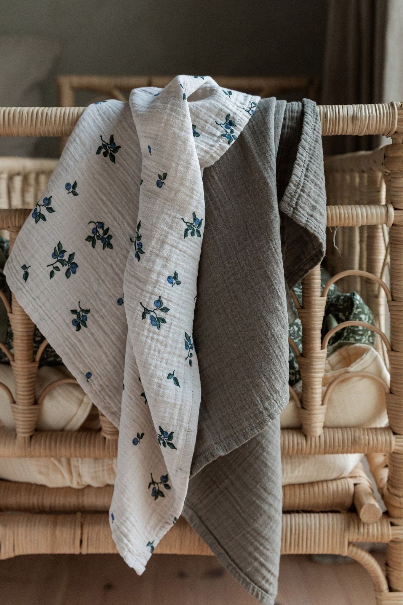 Blueberry Muslin blankets from Garbo&Friends, shown here hanging over a headboard, are versatile blankets that can be used for many things, making them perfect baby shower gifts.