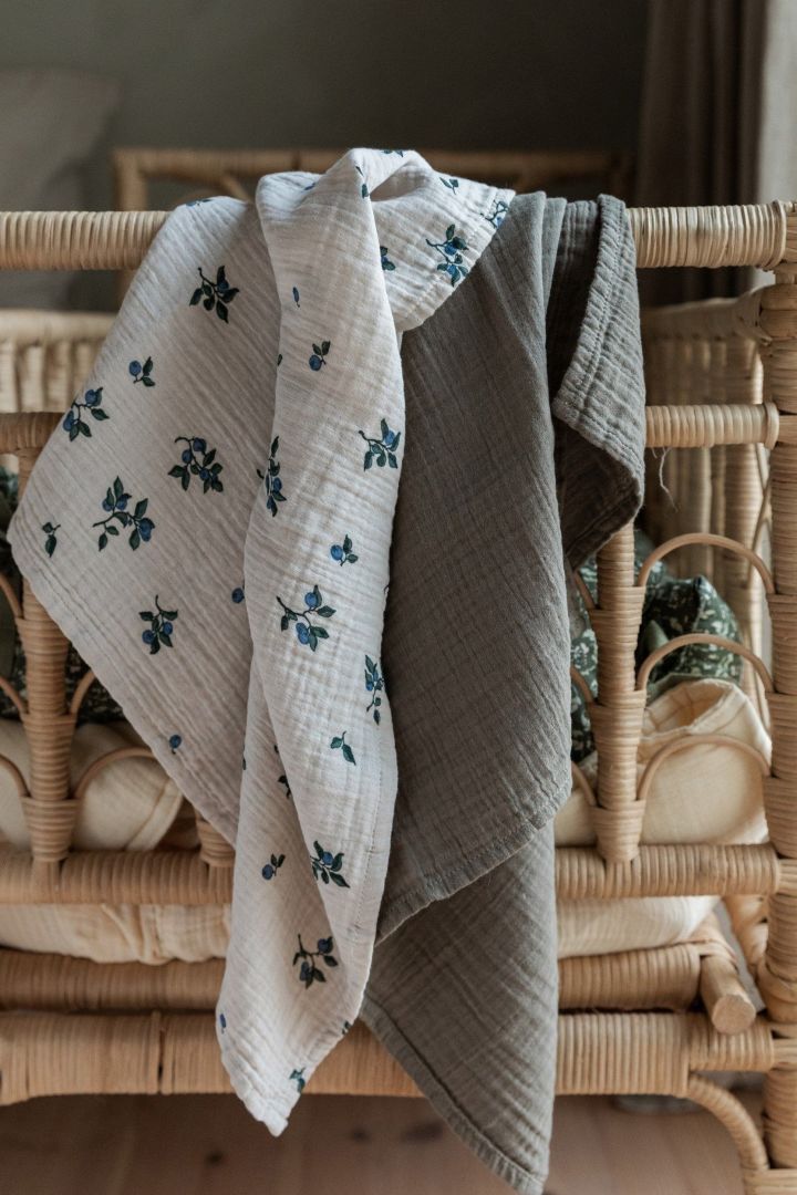 Blueberry Muslin blankets from Garbo&Friends, shown here hanging over a headboard, are versatile blankets that can be used for many things, making them perfect baby shower gifts.