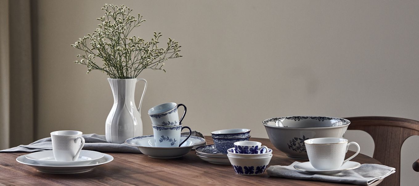 Mixed porcelain by Rörstrand on a walnut table. 