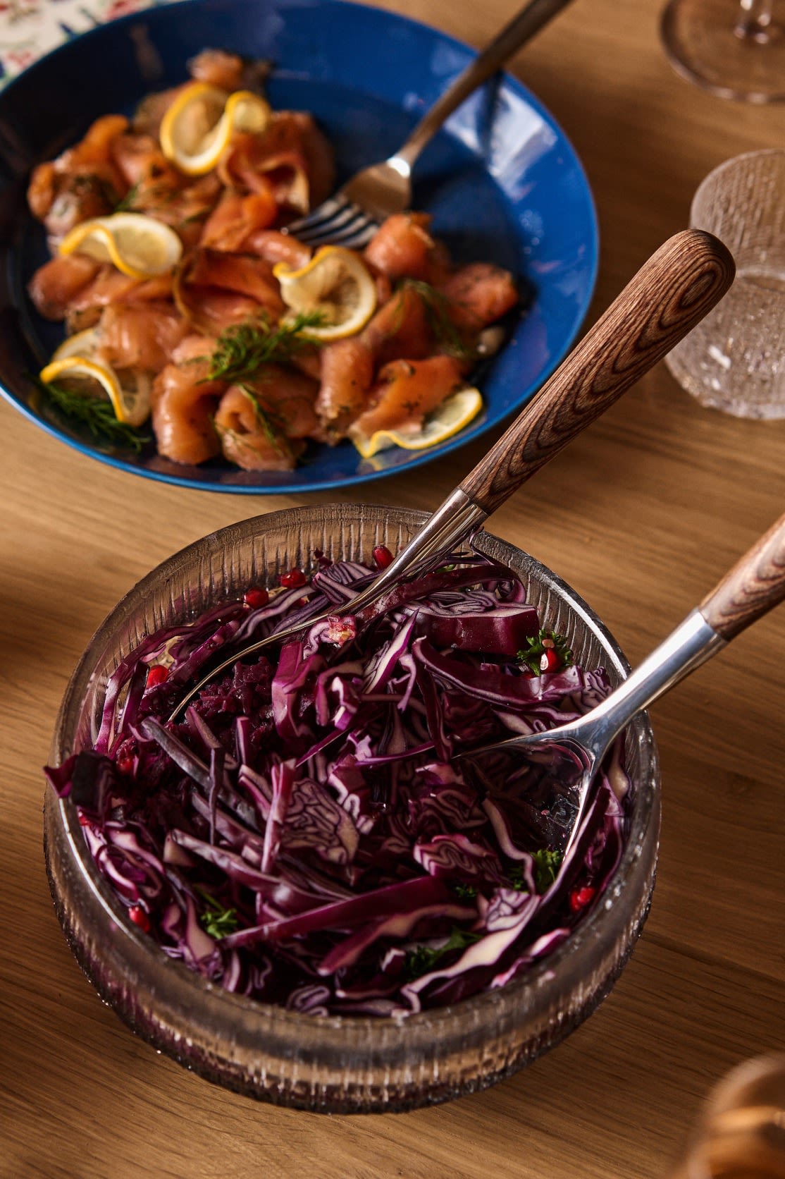 A finished cabbage salad with pomegranate stands on a Nordic Christmas table.