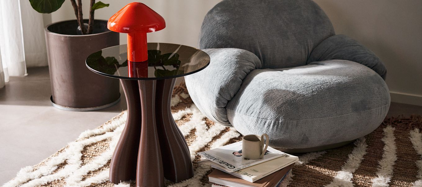 3D printed furniture is an environmentally friendly choice from Ekbacken Studios, here you see a living room with the anemone side table in the colour chocolate.