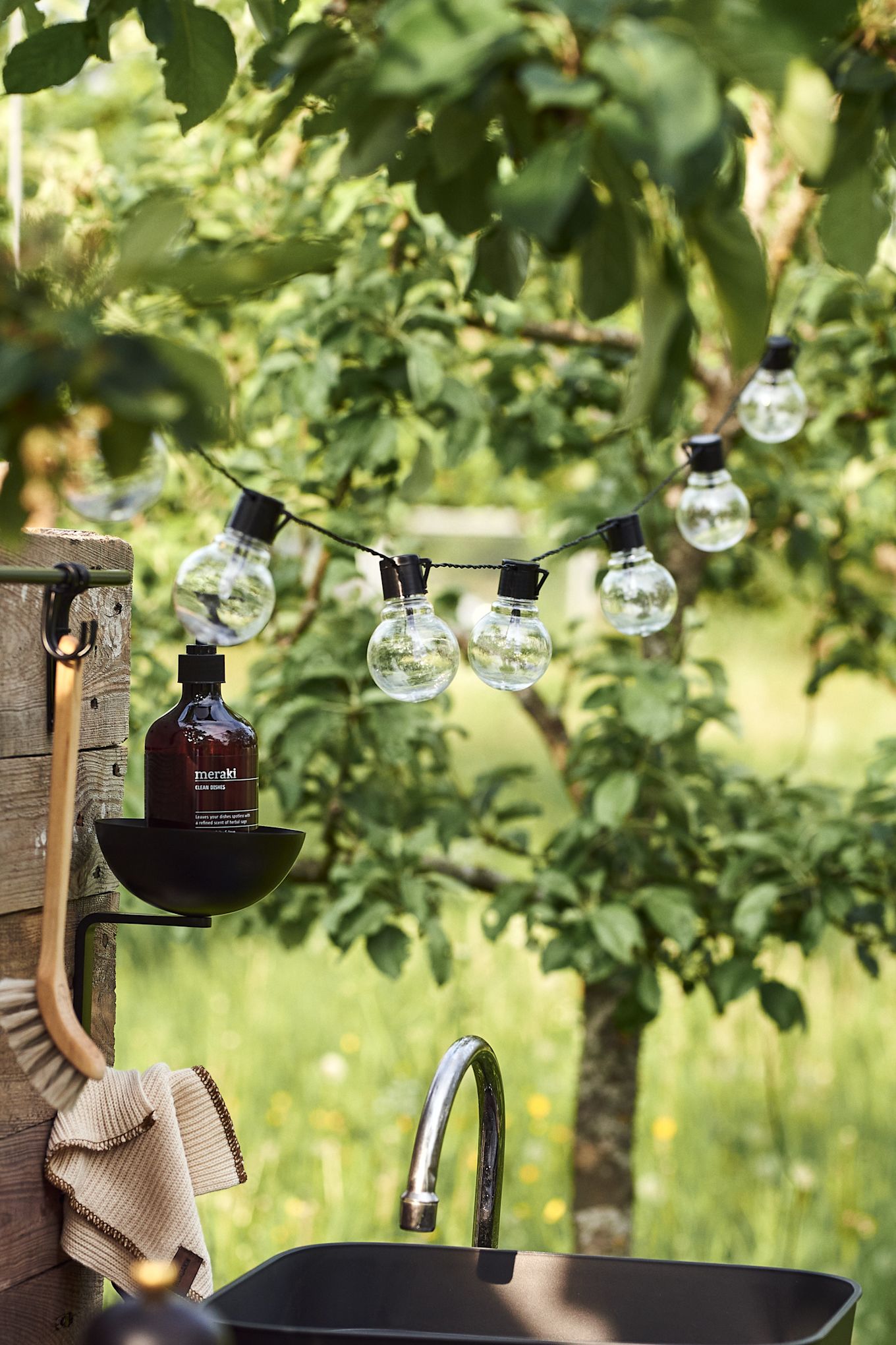 A string of lights adds the cosy factor to your simple DIY outdoor kitchen.