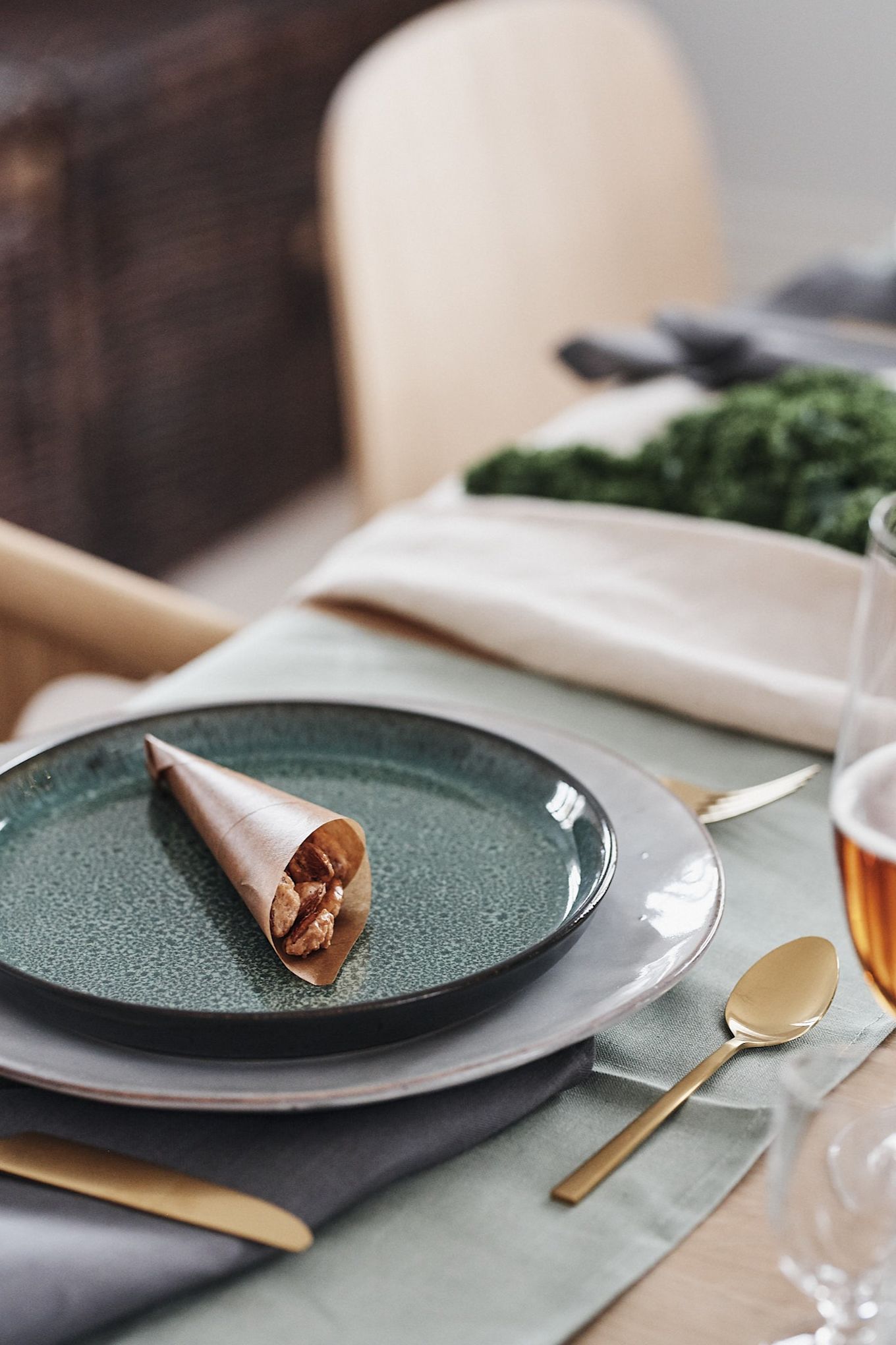 A paper bag with candied almonds on the plate will be a sweet decoration on the Christmas table.