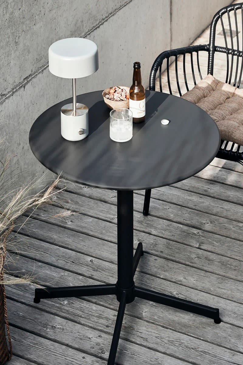 The small round Halo table from House Doctor seen here on a outdoor balcony is ideal for a small space.