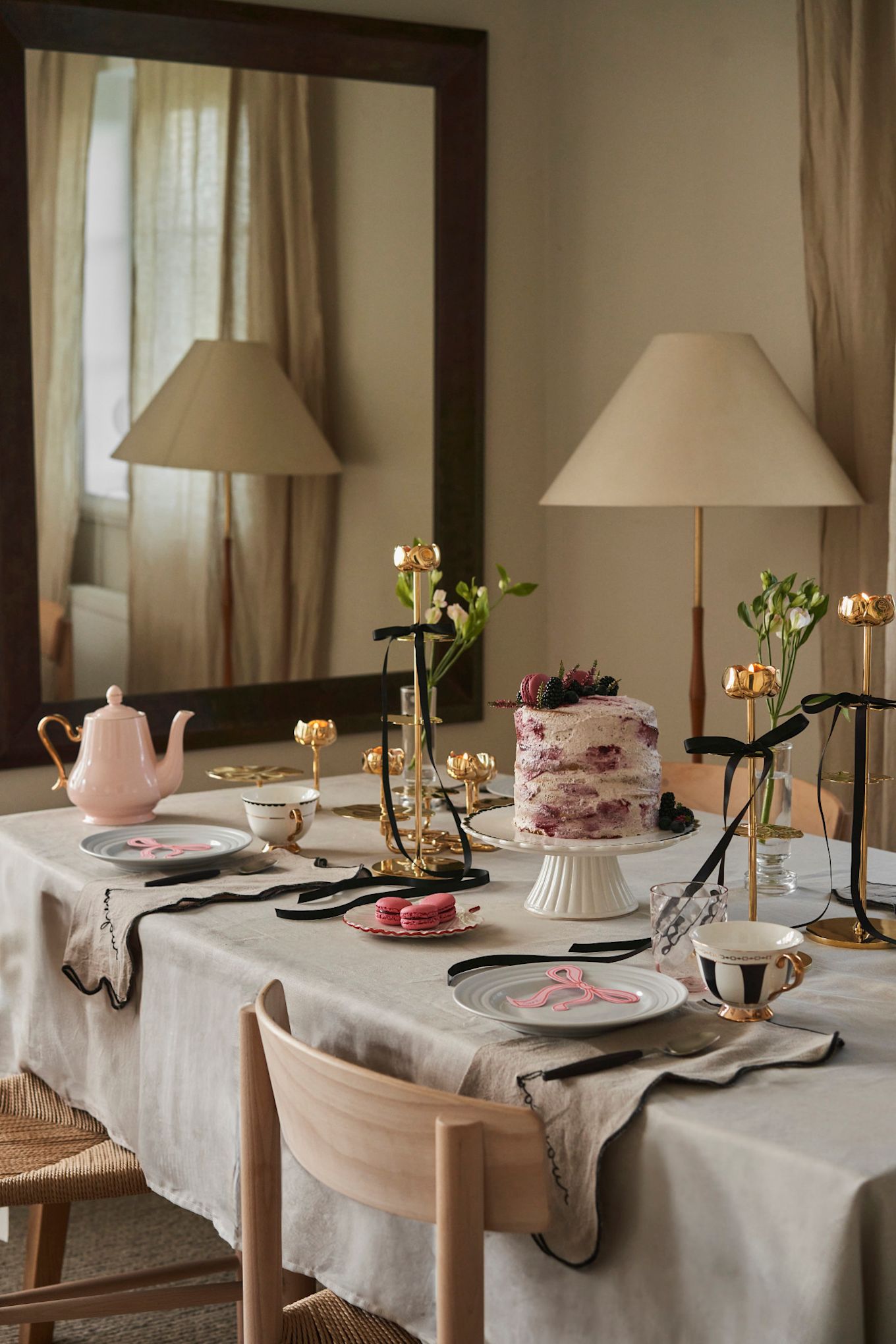 Celebrate Galentine's Day with a tea party at home with your favourite girl friends. Here you see a table set in pink and gold with black accents from Hilke Collection.  