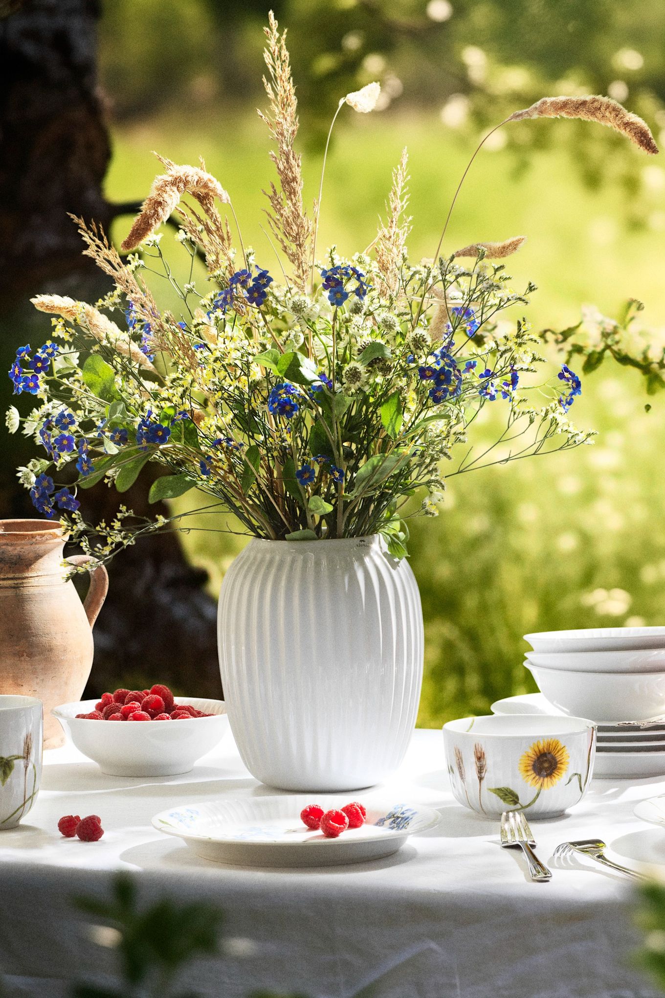 The simple clean lines of the Hammershøi collection for Kähler, seen here on a white vase in the summer sunshine.