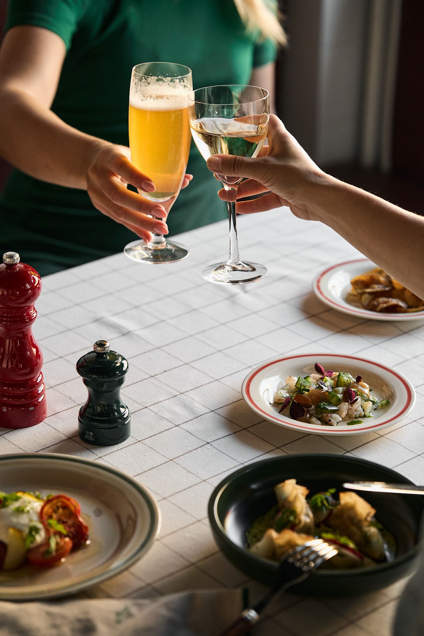 Chateau beer and wine glasses from Kosta Boda at a dinner party with dumplings and HAY plates.