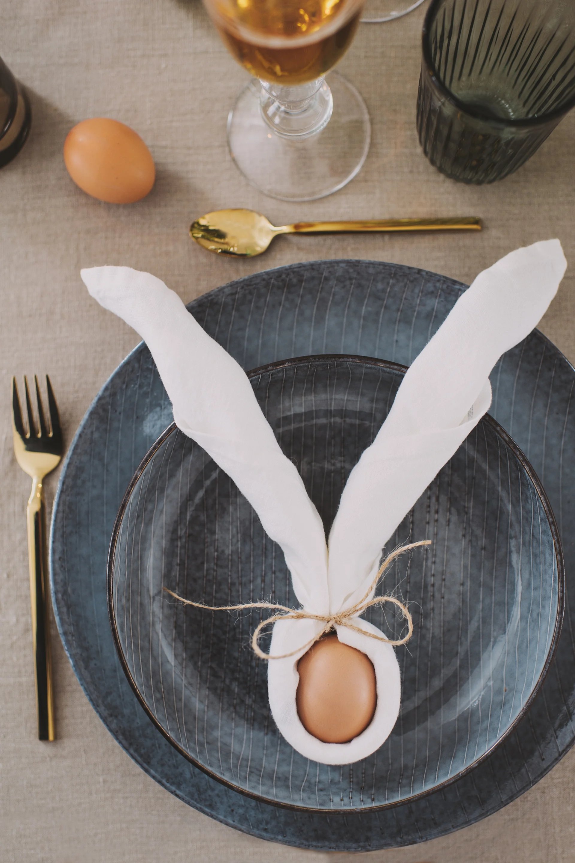 A linen napkin from Broste Copenhagen can with a simple napkin fold become a pair of rabbit ears, a playful addition to your Easter table setting.