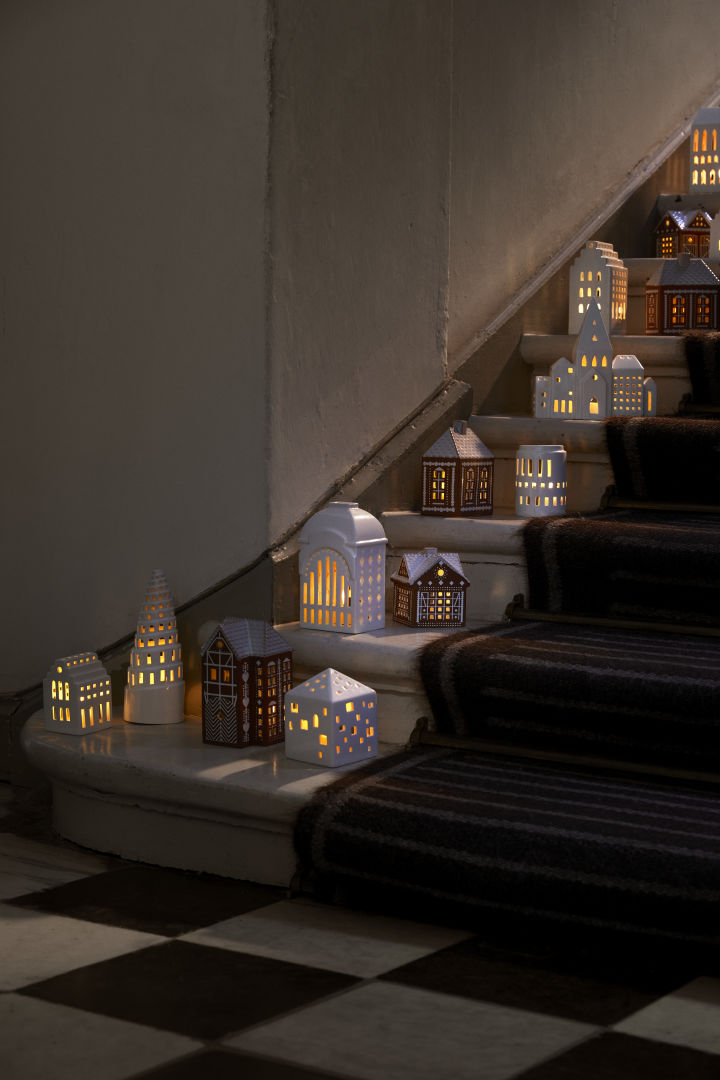 The Kähler candle houses in a collection on the stairs. Candle lit villages are very popular Christmas decorations in 2024. 