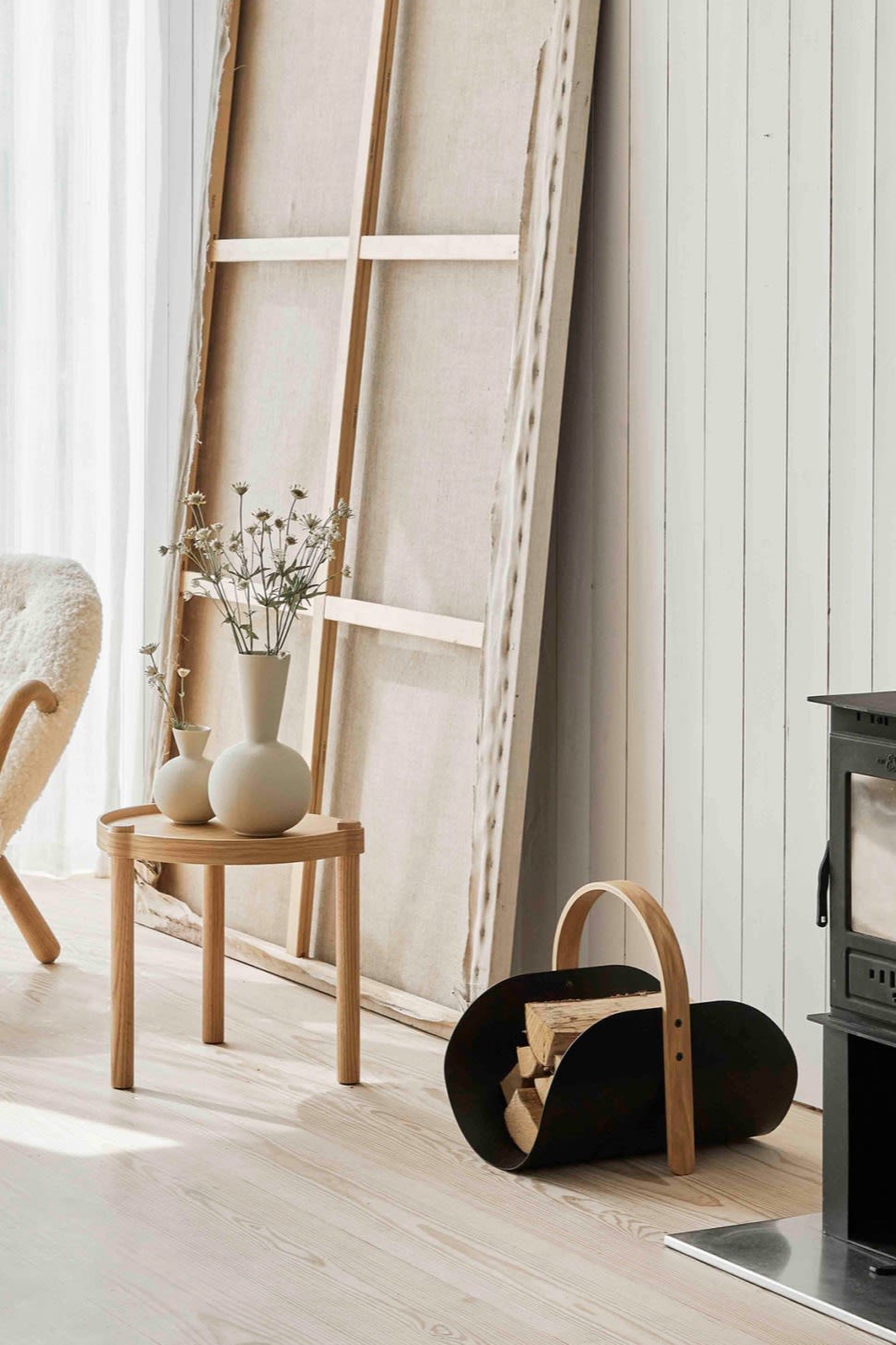 Two of the Cooee trumpet vases in shell stand on the Woody side table alongside the Woody wood basket. 