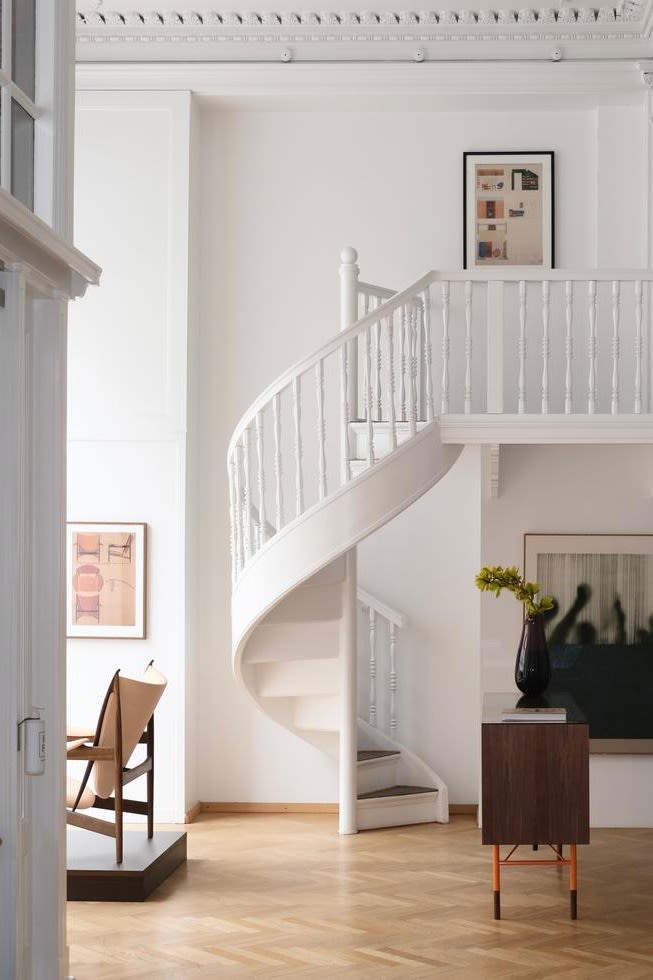 Here you see the crisp white, elegant showroom at House of Finn Juhl with its twisting staircase. House of Finn Juhl is a must visit for any design lover on a tour of Copenhagen. 