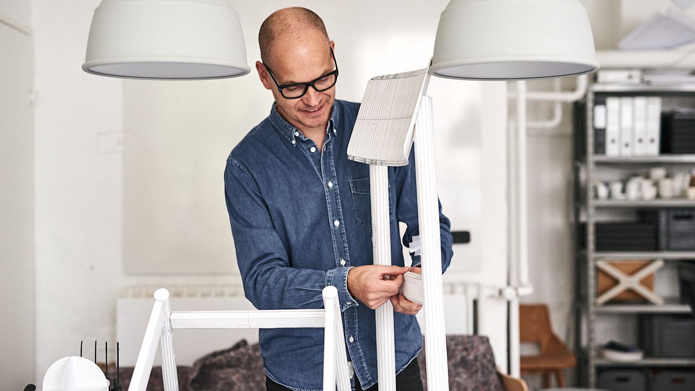 Thomas Bentzen in his studio in Copenhagen with a prototype of a chair.