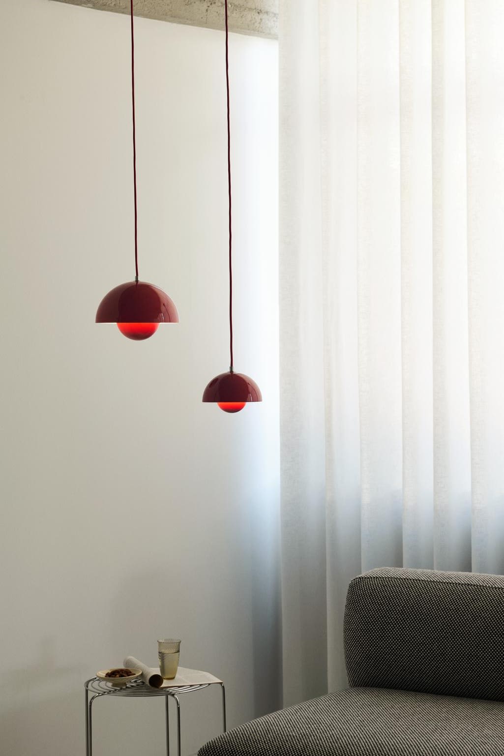 Update your home with these modern ceiling light ideas. Here you see the Flowerpot lamp from &Tradition in two different sizes hanging in a living room above a sofa.  