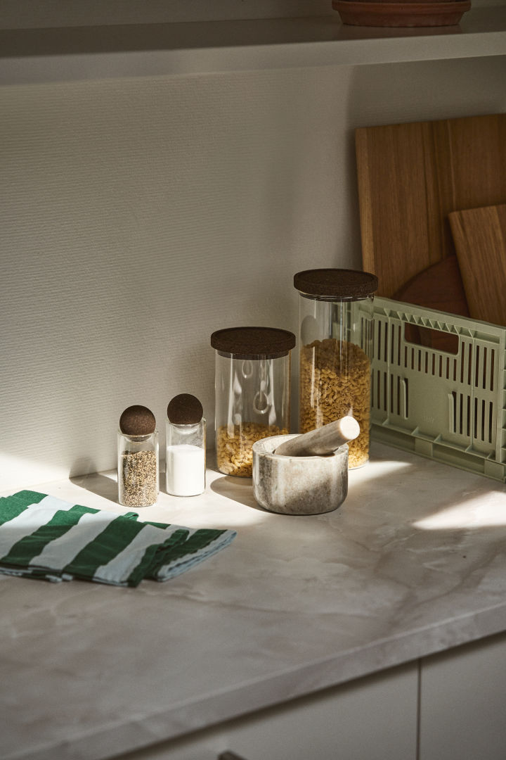 Get organised in the kitchen with the Saga Form storage jars and the HAY plastic storage basket seen here in a simple white kitchen. 