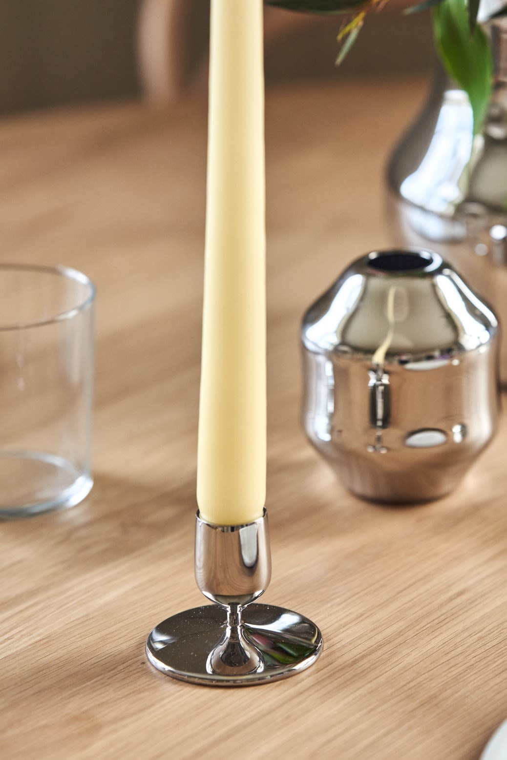 A close up of the short Dorotea candlestick in polished stainless-steel for Gense. 