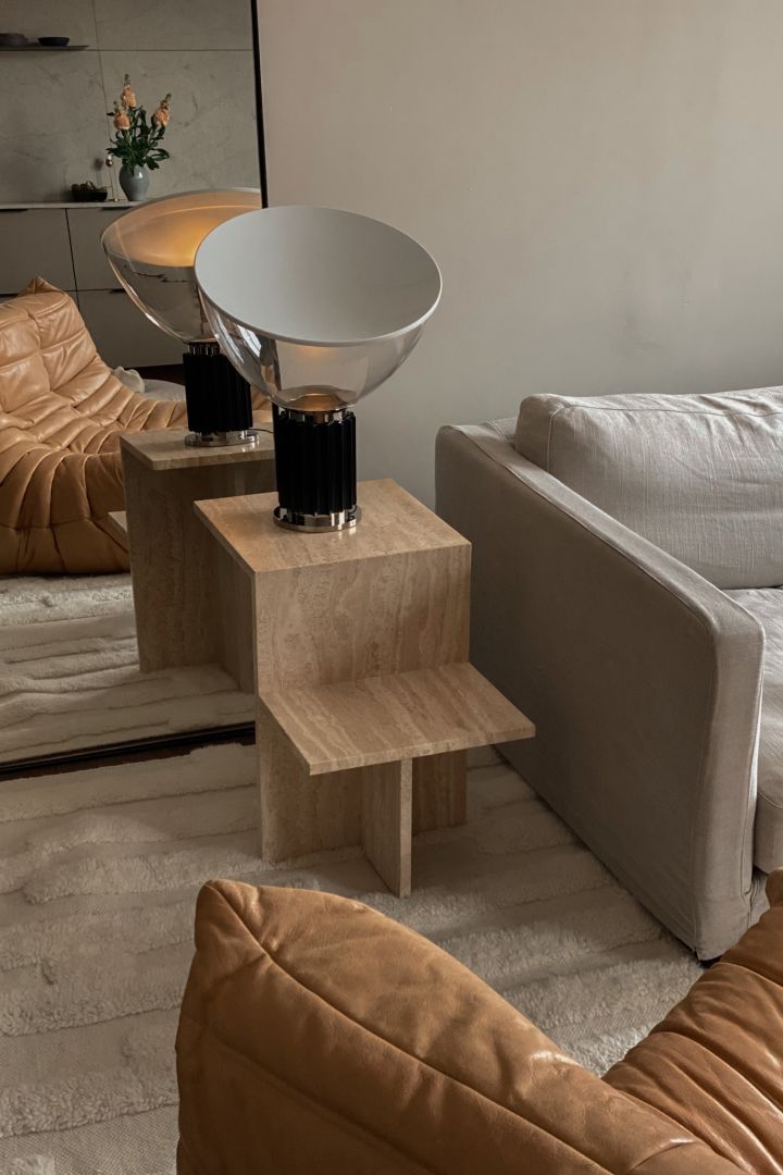 Modern lighting ideas for all areas of your home. Here you see the Taccia table lamp from Flos in the home of Elin Lansjö. It is standing on a travertine table from ferm LIVING, 