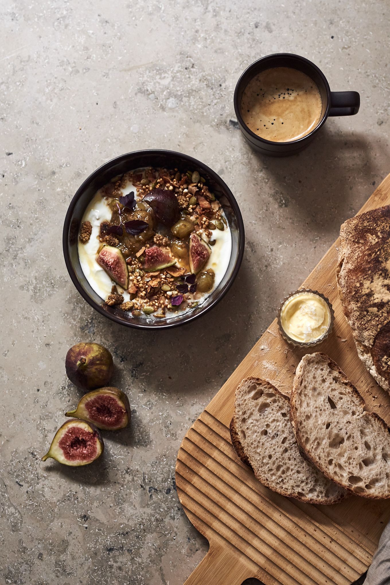 The NJRD Lines bowl in brown with müsli, sliced bread and a cup of coffee. 