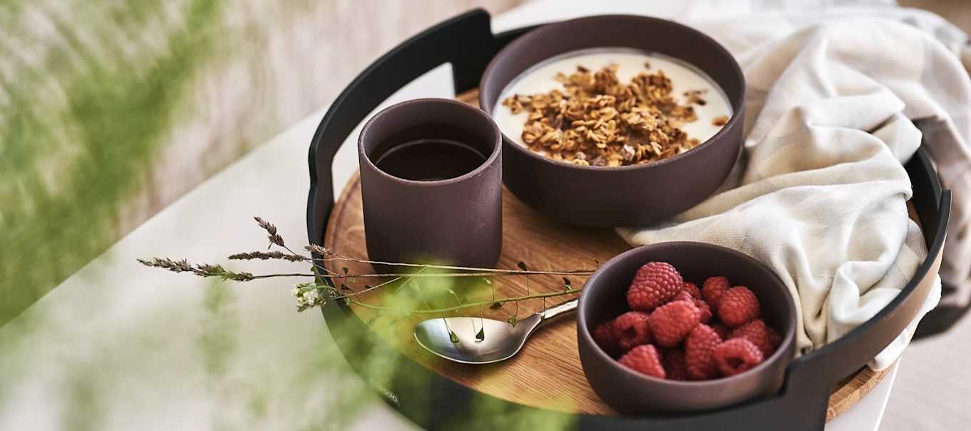 A simple and healthy breakfast is served on a tray from Eva Solo in bowls from Ferm Living for a luxury breakfast in bed.