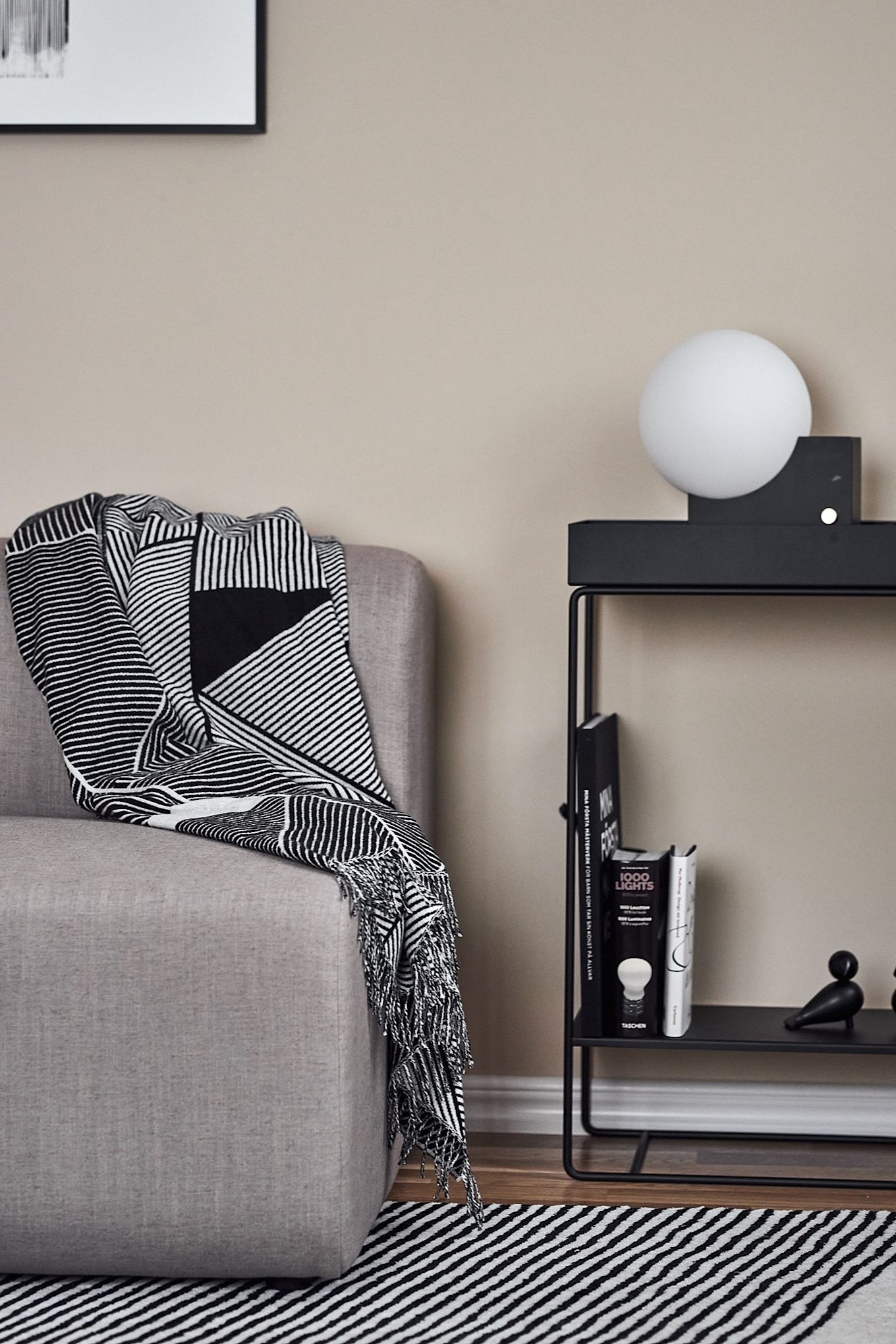 Graphic, black and white living room with Ferm Living console table, graphic plaid and rug from NJRD