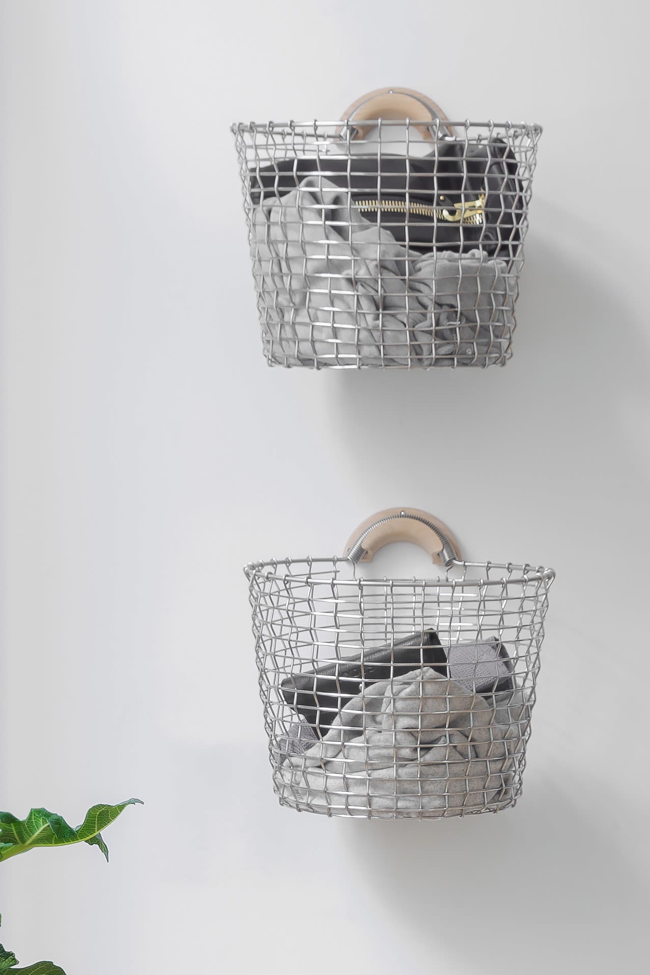 Storage ideas for small bathrooms - hang items on the wall to keep them off the floor, here you see the Korbo basket hanging on the wall as laundry baskets. 